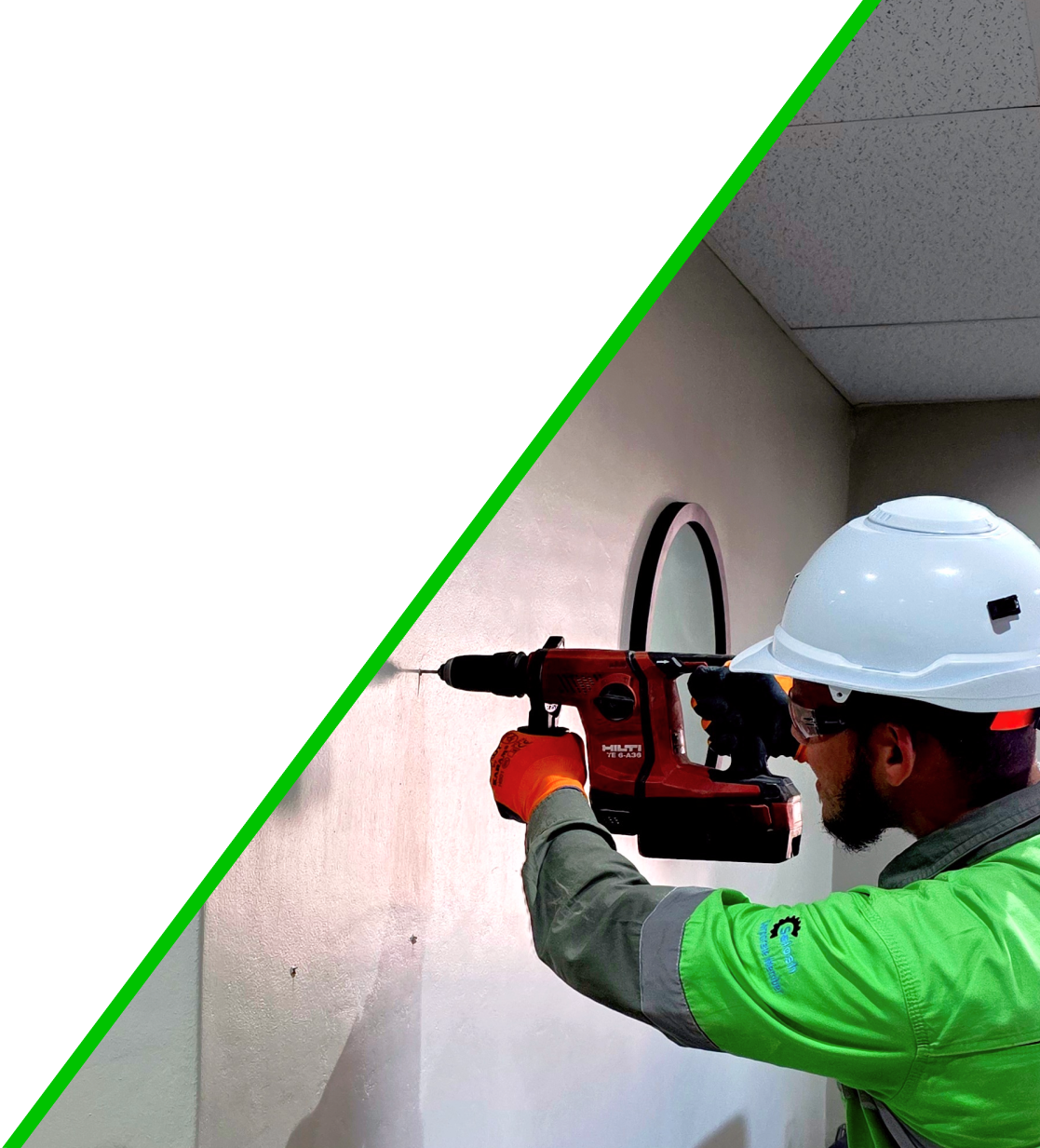 Worker drilling into a wall
