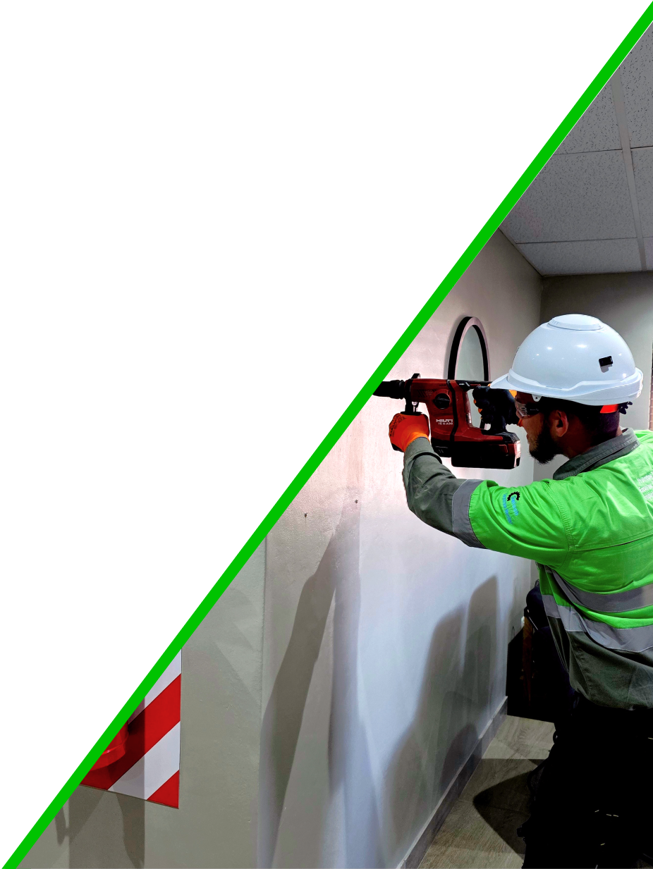 Worker drilling into a wall